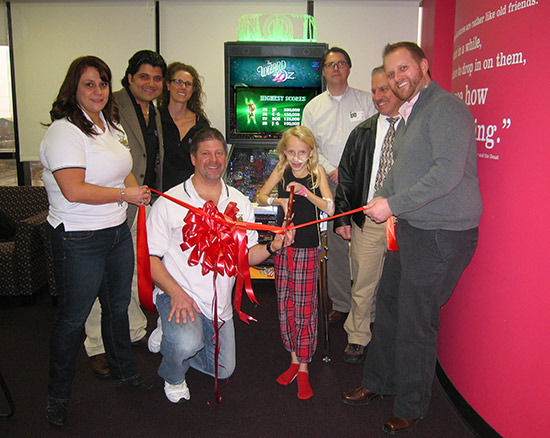 The ribbon is cut on the donated pinball machine