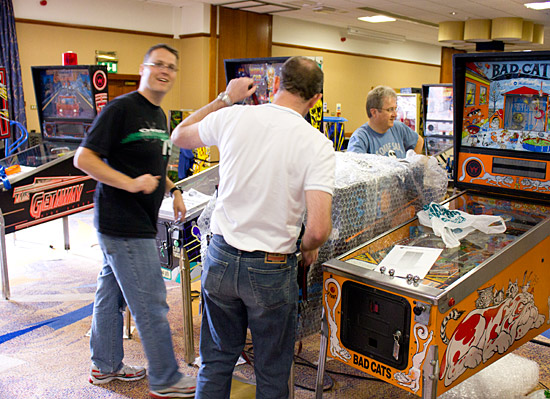 Nick Marshall, Phil Dixon and Mark Squires set up a machine for that evening's UK Pinball Team Tournament