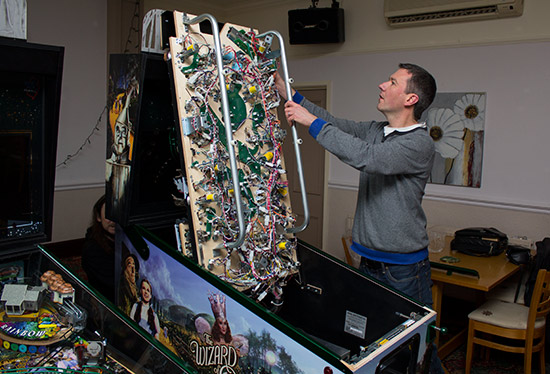 Pinball Heaven owner Phil Palmer sets up one of the machines