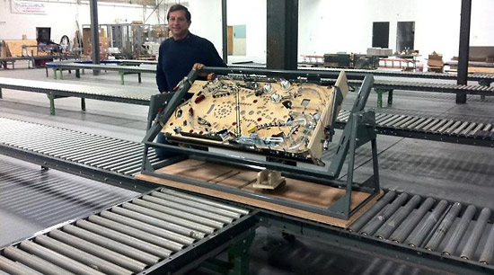 Jack Guarnieri poses with one of the prototype playfields