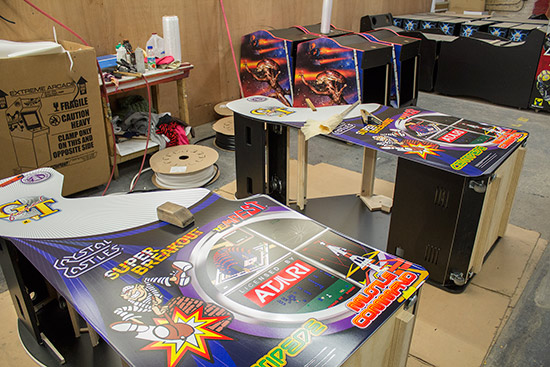 Decals being applied to video game cabinets