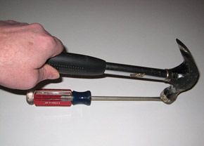 Striking a screwdriver with a hammer