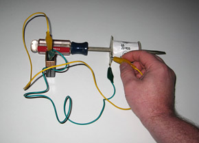 The screwdriver is magnetized by a coil