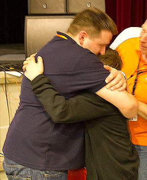 Franck gives his son a long hug