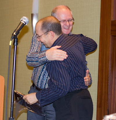 Gary Flower is congratulated by last year's inductee Jim Schelberg
