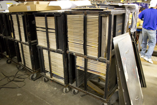 Racks of playfields with their metal drill templates