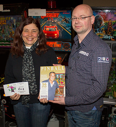 Second-placed Laurence Boulieu is presented with a copy of Pinball Magazine by its Editor, Jonathan Joosten