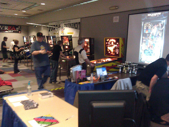 The NW Pinball Championship tournament area with a large projection display to follow play