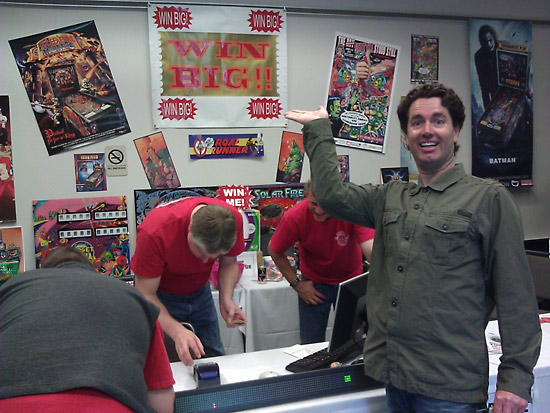 Eric Shaffer, visting from Salt Lake City, shows off the WIN BIG sign at the raffle desk