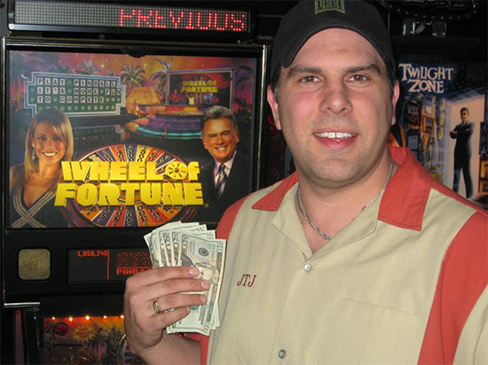 Survivor Pinball winner, John Jundt with his $100 prize