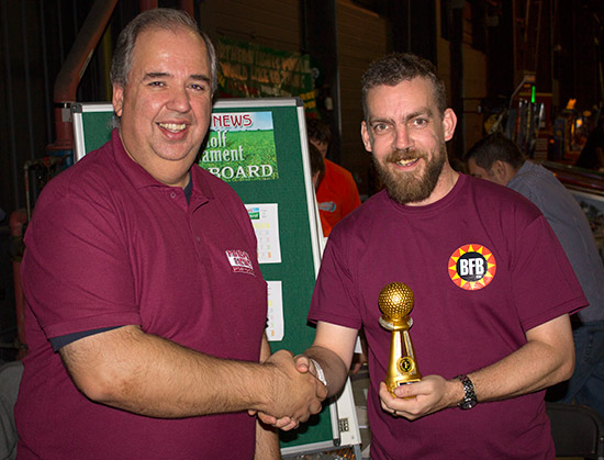 The winner of the PinGolf Tournament, Wayne Johns receives his trophy from Pinball News Editor, Martin Ayub