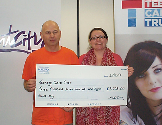 Mark Robinson presents the cheque to the Teenage Cancer Trust
