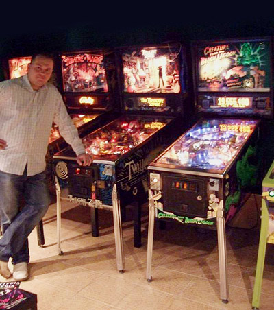 Mariusz in his basement with some of his best pinballs