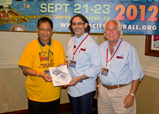 George and Gary present the sketches to the Pacific Pinball Museum's Ron Chan to help boost their fundraising project