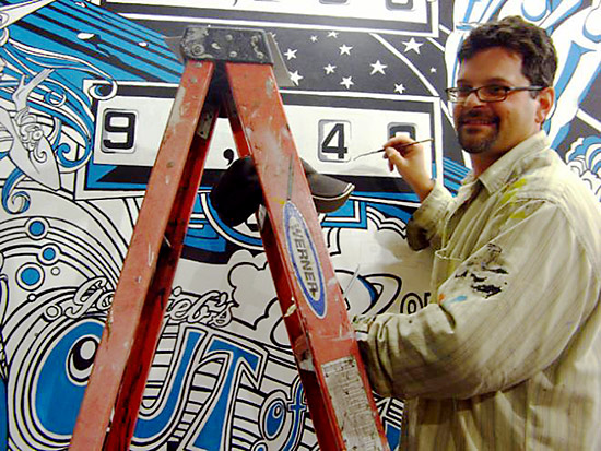 Artist Eric Kos as he develops his Gottlieb Out of Sight mural. PPM Archives