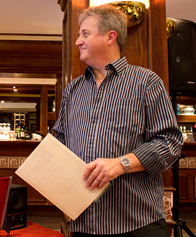 Mark Squires receives his trophy and certificate as he is inducted into the UK Pinball Group Hall of Fame