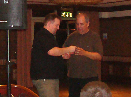 Andrew receives his award from Martin