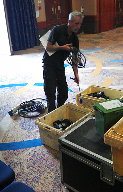 Head electrician, John Higgins, arranges the cables and distribution boxes so the machines have power