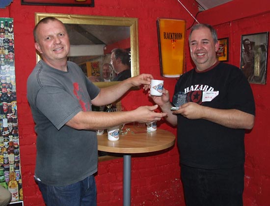 Martin Ayub collects his fourth place trophy and mug