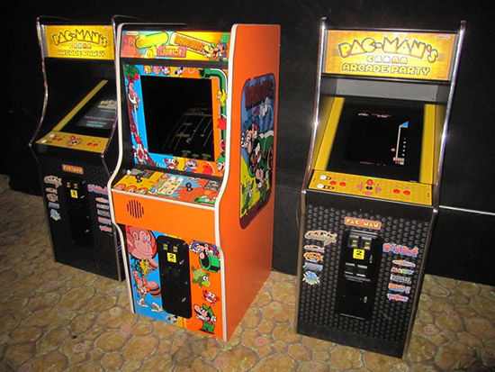 Some multi-title classic video game cabinets in the back of the pinball room
